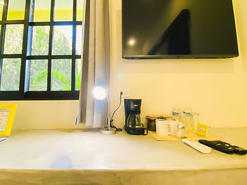 TV, coffee maker and window in the room