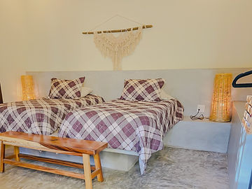 Two beds with plaid cushions
