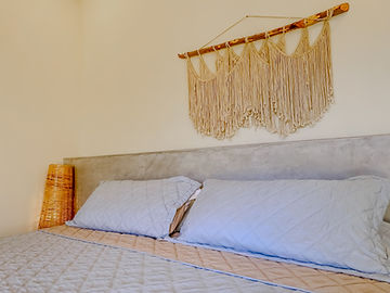 Detail of handmade macramé above the bed