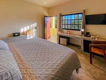 King bed, desk and window with ironwork