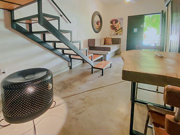 Sala y comedor del loft con escalera